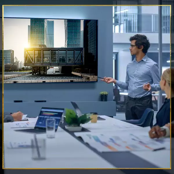 Professionals collaborating in office, framed by letter-shaped windows